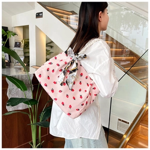 Pink corduroy tote bag with strawberry embroidery and silk scarf detail on shoulder strap