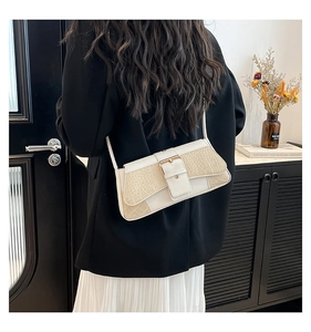 Chic white baguette shoulder bag with crocodile texture worn by model in elegant suit