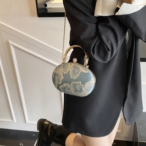 Elegant floral embroidered oval evening bag with gold chain strap for crossbody wear