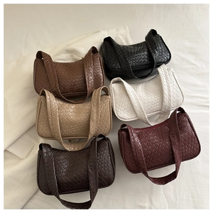 Collection of woven faux leather hobo bags in six colors on white fabric background