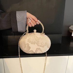 Champagne gold oval evening bag with relief floral pattern and diamond spherical lock