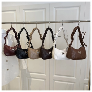 Détails de six sacs demi-lune tressés avec papillons métalliques et anses en forme de chouchou