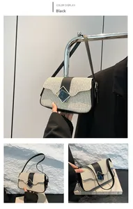 Detail of straw patchwork bag with black leather trim and geometric diamond buckle