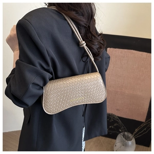Detail of beige woven texture shoulder bag with gold FASHION & BAGS lettering