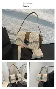 Detail of woven straw shoulder bag with brown leather trim and geometric metal buckle
