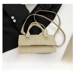 Beige textured handbag shown with a smartphone for scale, featuring gold metal trim