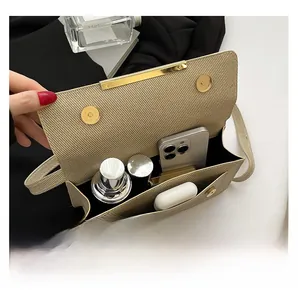 Detail view of the beige woven handbag interior showing compartments and daily storage space