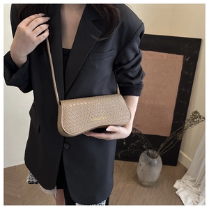 Crossbody view of a khaki crocodile pattern small square bag with fashion text detail