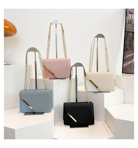 Detail of four colorful crossbody bags with diagonal textures and golden metal accents