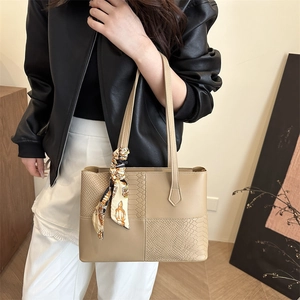 Beige faux leather tote bag with crocodile texture and silk scarf accent on handles