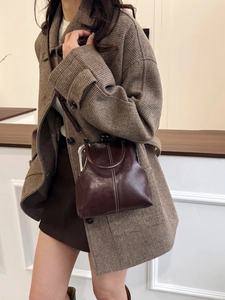 Close-up of vintage brown leather doctor bag with contrast stitching and metal clasp