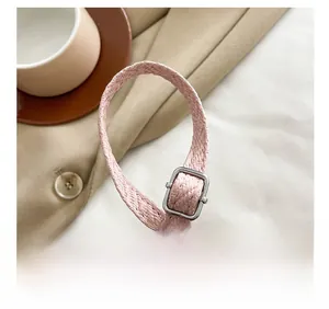 Detail shot of the pink braided adjustable shoulder strap with silver metal buckle