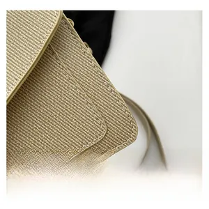 Macro shot of beige woven fabric with premium dual stitching on the shoulder bag detail