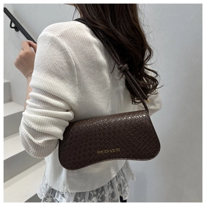Brown crocodile embossed underarm bag shown on model with shoulder knot detail