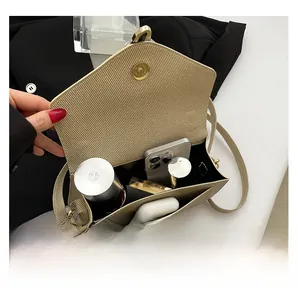 Interior view showing capacity for phone and makeup in beige woven texture crossbody bag