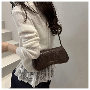 Detail showing the dark brown woven texture and gold fashion logo on the hobo bag