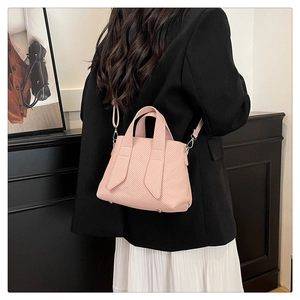 Detailed view of light pink striped textured tote bag with detachable shoulder strap