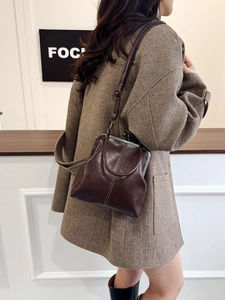 Detail of vintage brown leather doctor bag with bronze metal clasp and adjustable strap