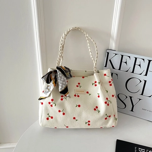 Minimalist white corduroy tote bag with cherry print and decorative silk scarf detail