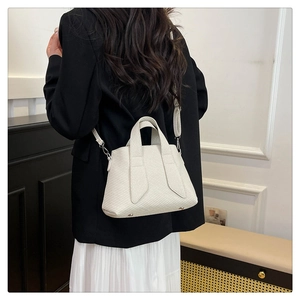 Detailed back view of a white textured tote bag showing high-quality stitching and handle