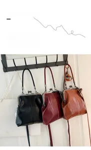 Three vintage doctors bags in black, burgundy and brown with metal frame and thin straps
