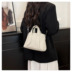 Modern woven tote bag in cream white showing practical size and elegant shoulder strap