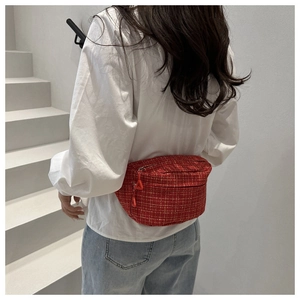 Sac ceinture en tweed rouge porté à la taille avec motif tissé et détails de fermeture