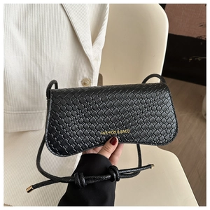 Detail of black woven leather texture and golden Fashion & Bags logo on the handbag