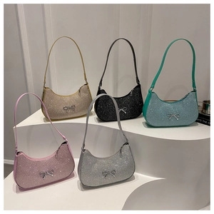 Close-up of glitter hobo bags with silver bow buckles in five assorted vibrant colors