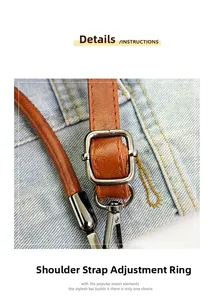 Detail view of the brown leather shoulder strap with adjustable metal buckle and carabiner hook