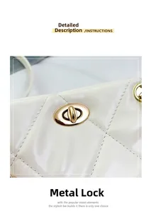 Detailed macro view of the gold-tone metal twist lock on a quilted cream leather bag