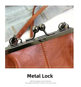 Close-up of vintage brown pebble leather handbag with gold double ball metal clasp