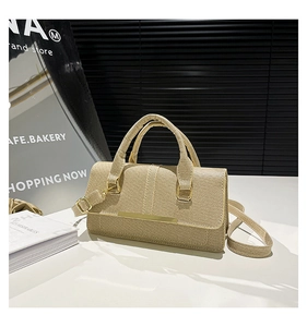 Detail of beige woven texture handbag with sleek gold metal clasp and sturdy handles