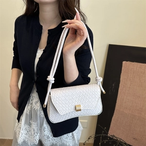 White woven leather underarm bag with gold buckle and knotted shoulder straps