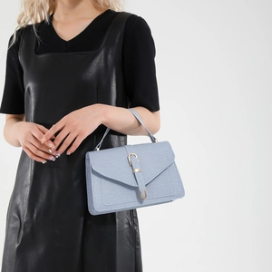 Chic light blue denim crossbody bag with gold horseshoe buckle for women's fashion