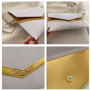 Macro detail of wave texture and magnetic buckle on cream envelope clutch bag