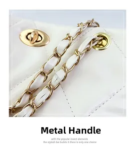 Detail of white quilted leather bag showing gold twist lock and chain strap