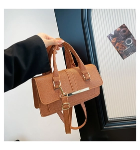 Brown woven texture handbag with sleek gold metal trim and adjustable shoulder strap