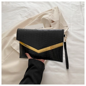 Detail of black envelope clutch featuring gold V-metal trim and epi water ripple texture