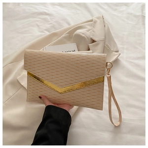 Detail view of beige envelope clutch bag with wavy texture and golden V-shaped trim