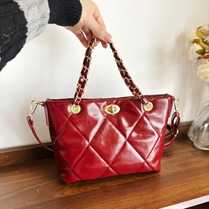 Red quilted patent leather tote bag with gold chain strap and turn-lock closure