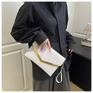 Detail of white textured leather envelope clutch with gold V-shaped metal trim and wristlet