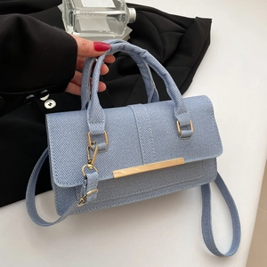 Minimalist light blue textured crossbody bag with gold metal trim and top handle