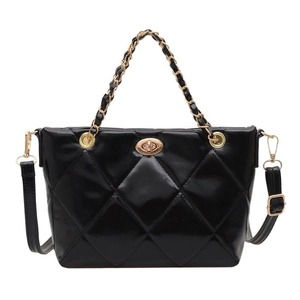Glossy black quilted handbag with golden twist lock and chain handle on white background