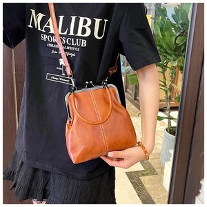 Close-up of retro brown doctor bag with metal frame closure and fine stitching details