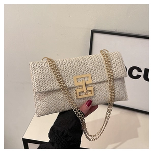 Close-up of beige woven crossbody bag with gold chain and square metal clasp detail