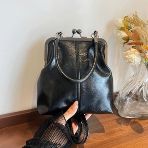 Vintage black patent leather frame bag with metal clasp and top handle for women