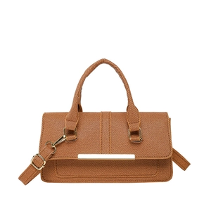 Brown textured shoulder bag with golden hardware and adjustable strap in minimalist style