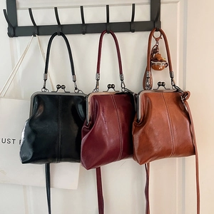 Retro vintage kiss-lock doctor handbag in black, red and tan leather with long strap