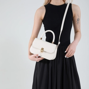 Elegant off-white commuter handbag with golden lock and adjustable strap for women
